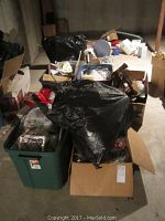 Overall photo of boxes and bins full of Christmas decor items stacked in a basement or storage room area