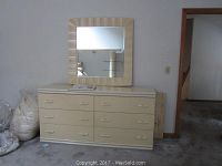 Front view of the 6-drawer lacquered dresser with matching mirror above it.