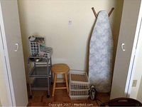 Photo showing all items together: ironing board, wire basket, wooden stool, storage baskets, metal 3-tier shelf on wheels, electric iron