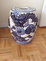Full side view showing blue dragon design and ceramic texture of drum table.