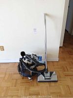 Full view of vacuum cleaner with wand, powerhead, canister and hose