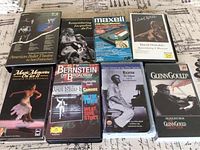 Eight assorted VHS tapes including titles related to ballet, classical music, and documentaries arranged flat to show front cover artwork and titles.