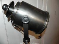 Close-up of the black metal spotlight lamp head showing the construction and tilting mechanism.