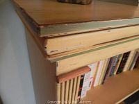 Close-up of the top edge showing distressed paint layers with cream and green tones and peeling effect.