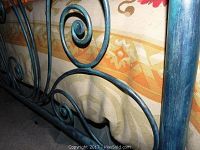 Close-up of headboard scrollwork and painted finish