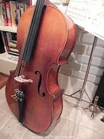 Three-quarter front view of wooden cello showing body, f-holes and fingerboard