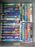 Top-down view of Disney VHS tapes including Flubber, Oliver & Company, Pocahontas and others.