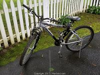 Full side view of the Rhino Hydro XR3 triple pivot aluminum frame bike showing frame details, tires, handlebar, and seat.