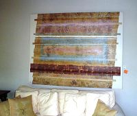 Full view of the oversized abstract canvas art hanging above a sofa, showing the textured horizontal patterned design