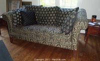 Front view of sofa showing embroidered damask pattern, cushions and overall condition