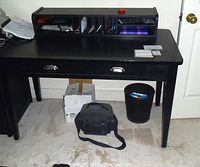 Front view of assembled desk with hutch, items placed for scale (contents not included).