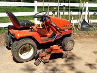 Side view of tractor with mower deck attached