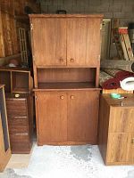 Front view of assembled two piece wood cabinet with closed doors.