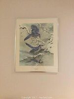 Full view of the framed print showing two blue jays in a snowy winter scene by the water.