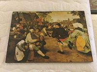 Full view of mounted print depicting a lively country dance scene with figures in period dress in a village setting.