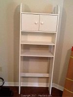 Full view of tall white over-the-toilet bathroom cabinet with closed doors and two open shelves below.