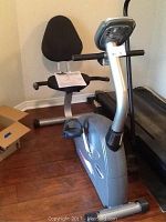 Full side view of Free Spirit magnetic recumbent exercise bike showing seat with backrest, pedals, and control console.