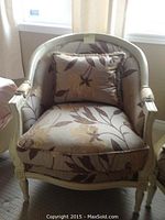Front view of cream-painted wood tub chair with floral upholstery and seat cushion