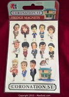Front view of sealed Coronation Street fridge magnets pack with 13 character magnets and Rovers Return Inn magnet visible.
