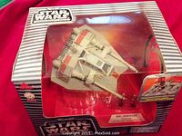 Unopened Star Wars Rebel Snowspeeder toy in original box. Box and figure details visible through window.
