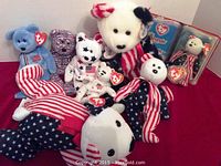 Overview of eight TY USA Bear plush toys in various patriotic colors and patterns, all with original tags.