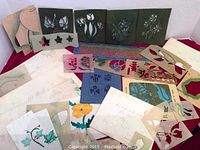 Photo shows an assortment of stencil sheets with various floral and seasonal designs spread out on a flat surface.