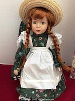 Front view of the Anne of Green Gables doll showing dress, apron, hair and facial features.