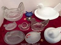Full view of various chicken on nest figurative dishes including milk glass, clear glass, and blue glass small dish.