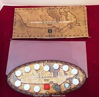 Full view of Millennium coin set with oval display showing 14 coins and original packaging box with vintage map design.