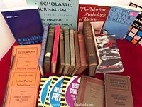 Photo showing a collection of vintage educational and literary books arranged on a red surface.