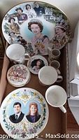 Overview photo of plates, cups, mugs, and lidded dish showing royal family images and emblems.