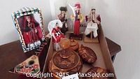 Photo of ethnic dolls and carved wood lidded dishes in a box