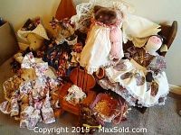 Photo showing six teddy bears dressed in varied floral and lace clothing sitting on and near a small wooden bench.