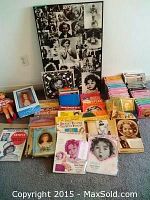 Photo showing the two Shirley Temple dolls, VHS tapes, Shirley Temple book, vintage magazines, and a Shirley Temple poster in the background.