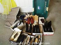 Shows multiple pairs of ladies shoes and boots in boxes, with a green laundry basket and a shoe rack on the side