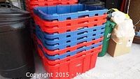 Stack of red plastic storage bins