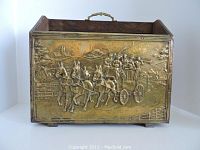 Front and side view of wooden and brass magazine holder featuring embossed horse-drawn coach scene