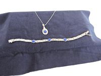 Pendant with a chain alongside the matching sterling silver bracelet with three lapis lazuli stones.