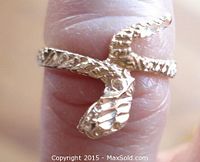 Close-up photo showing the detailed open mouth of the snake ring on finger.