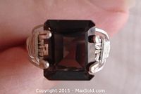 Top view showing emerald cut smoky quartz set in silver wired prong setting