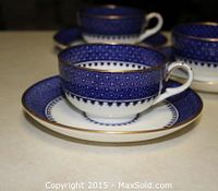 Set of 5 antique Wedgwood England cobalt blue and white teacups with matching saucers, showing the intricate geometric pattern and gold rims.