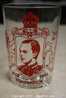 Side view of clear glass with red printed portrait of King George VI, crowned emblem, and May 1937 Coronation text.