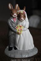 Front view of the Bunnykins Wedding Day figurine showing the bride and groom rabbits in wedding attire, holding a bouquet.