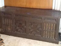Front view of the large vintage wooden Curtis Mathis record cabinet with detailed carved panels.