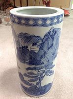 Front view showing detailed traditional Chinese landscape art with mountains, trees, and small structures.