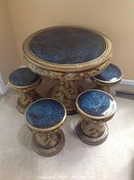 Full set view: round table and four stools on carpet against wall