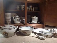Hand-painted Overjoy china set with various plates, bowls, teapot, sugar pot and gravy boat, all decorated with blue and gold dragon designs.