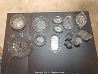 Top view of all glass dishes arranged on dark surface showing variety and details.
