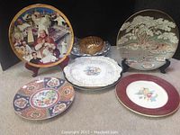 Photo showing six decorative items including a Pope Paul II plate, Royal China gold-trimmed plate, large bowl, serving dish, and two floral decorative plates.