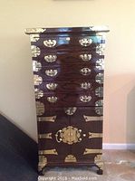 Full front view of cabinet against wall showing overall appearance and hardware